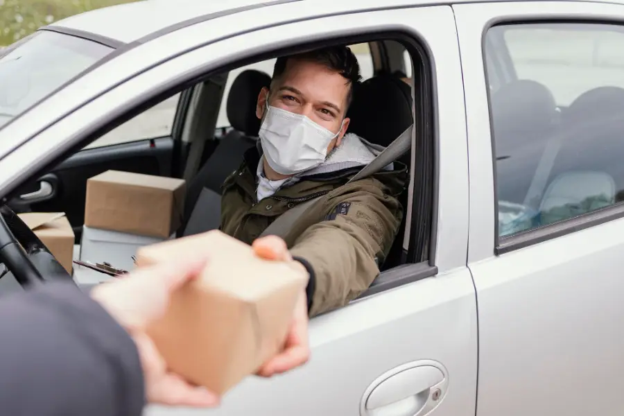 Delivery male with mask and packages